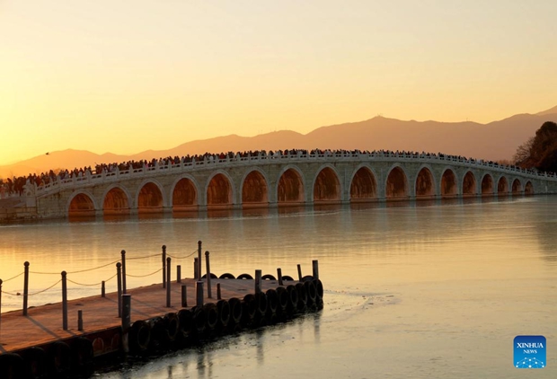People visit 17-Arch Bridge in Summer Palace, China