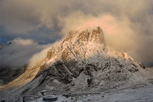 Magnificent holy mountain embraced by clouds in SW China